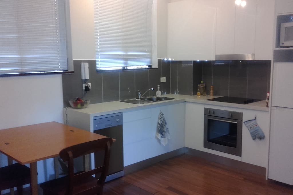 The kitchen, including dishwasher, fridge, oven, and spice pantry