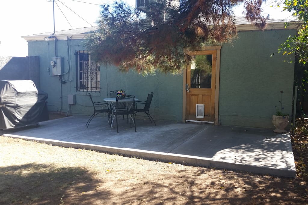Back patio. Has a gas BBQ grill, table, chairs, lovely evening lights and plenty of shade. All, surrounded by 6' block wall. Very private and pet secure.