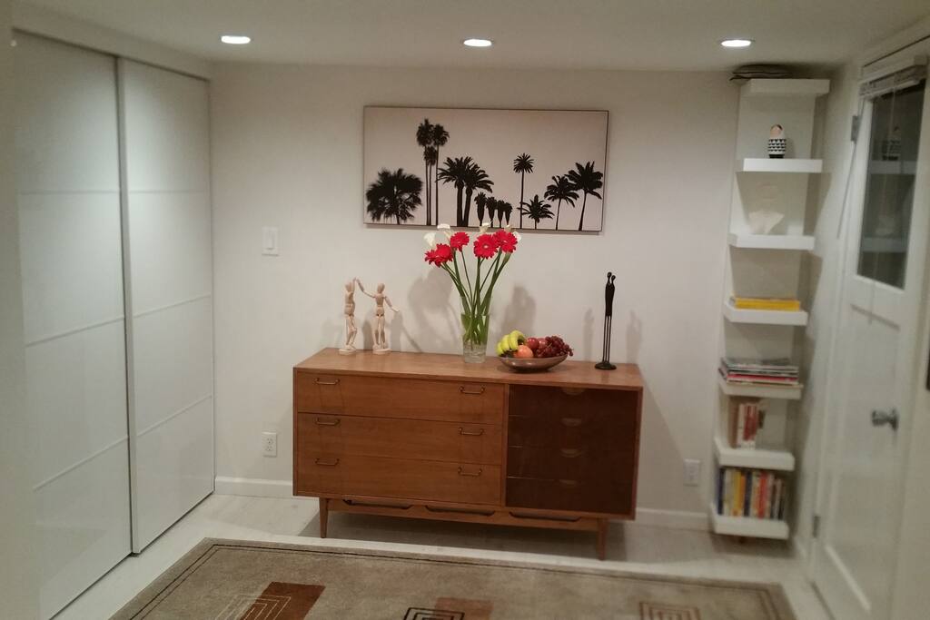 Reclaimed wood dresser; high gloss, sliding door closet; bookshelf; recessed lights with dimmer.