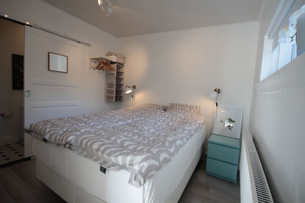 The bedroom with queensize bed and some space for clothes