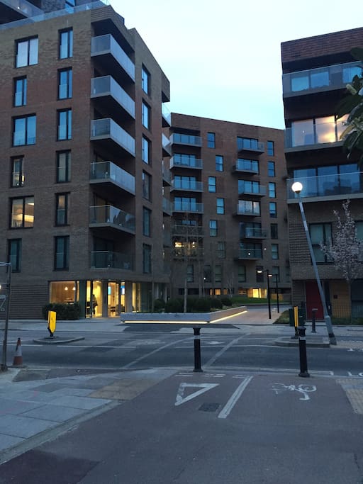 View of the flat building entrance with the concierge lights on at the bottom left corner.