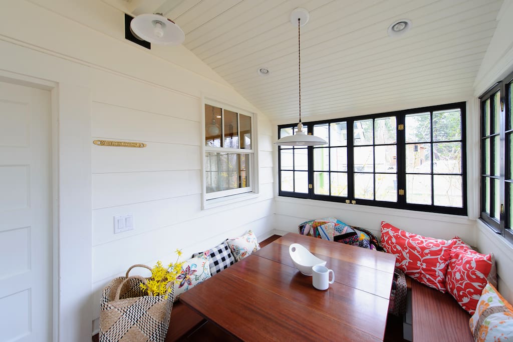 Sunroom for morning coffee or game night. The house is stocked with games and guidebooks.