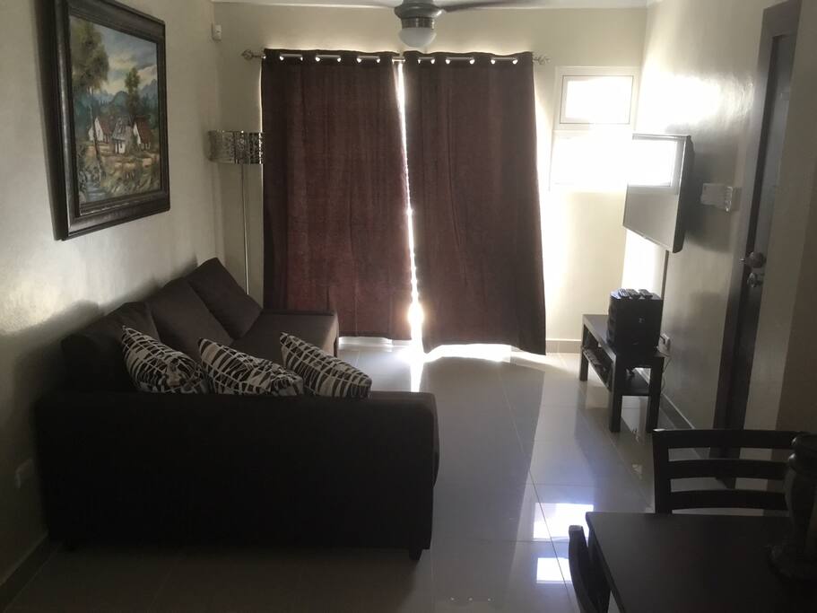 Living room area , Curtains covering the door to the balcony.