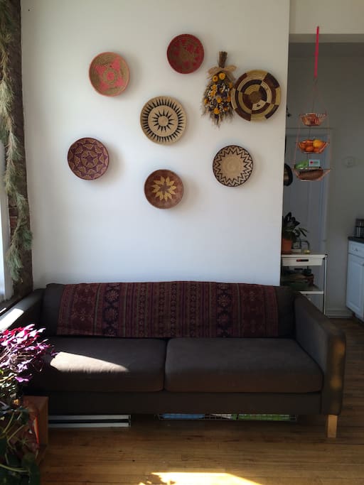 Our couch in the common area. Annie's collection of baskets on the wall.