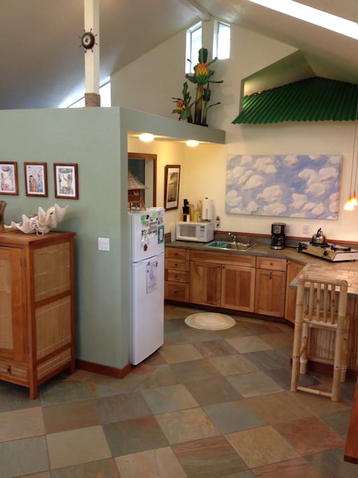 Quartzite slate tile floors, kitchenette with fridge, gas cooktop, toaster, microwave, blender, toaster oven.