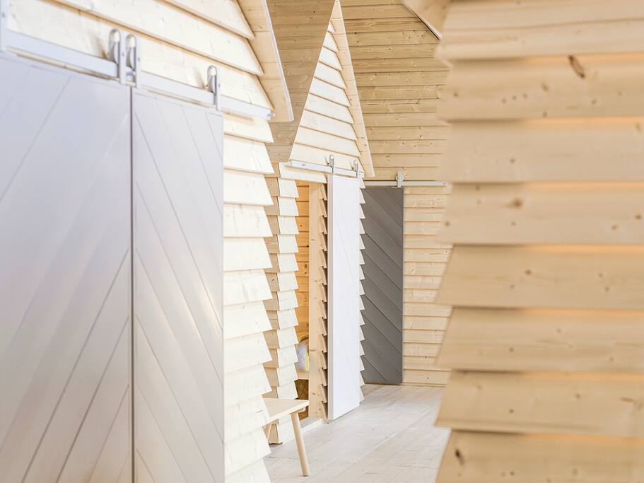 Each evening, up to 12 guests can book from a selection of six spruce timber aitta. Each day, the installation is open for the public to visit.