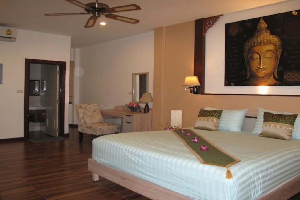 Spacious rooms with air conditioning and overhead fan.