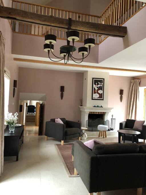 Beautifully decorated living room with open fireplace for those colder evenings. Open to the rafters, with mezzanine area above for reading and lounging in front of upstairs TV (with PlayStation)