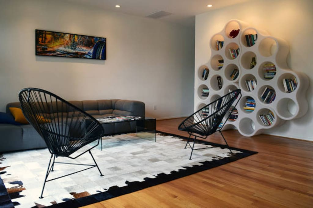 Neato living room with hip furniture that you are welcome to lay upon.