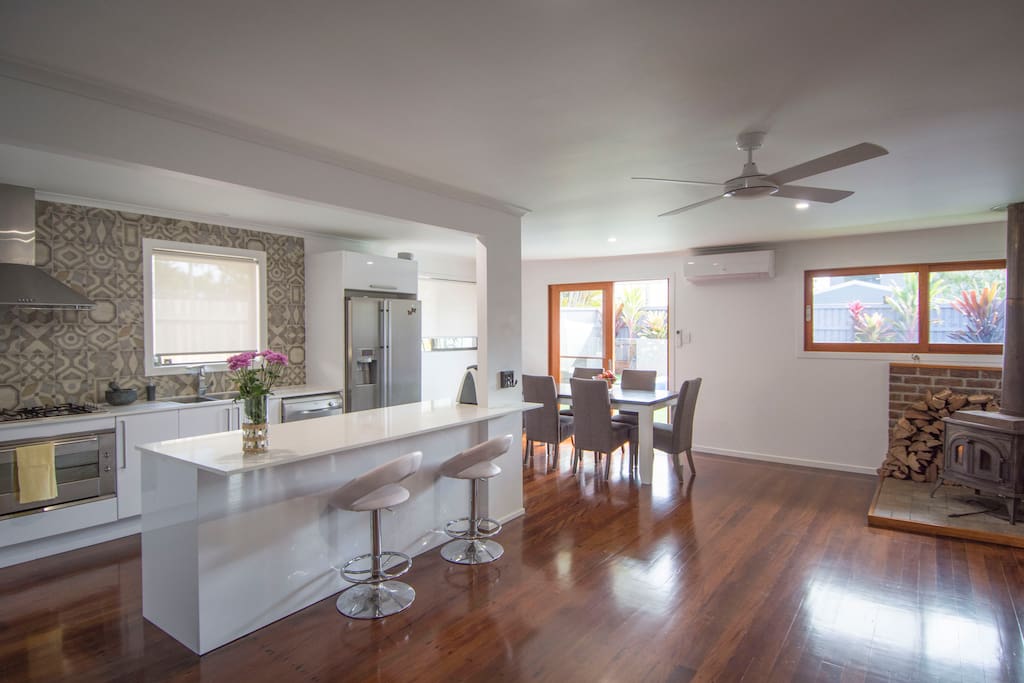 Fully equipped kitchen and open living and dining area looking out onto the pool
