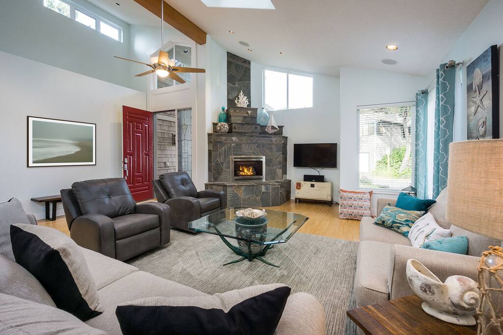One-of-a-kind glass table and rock fireplace are one of many custom features of this home