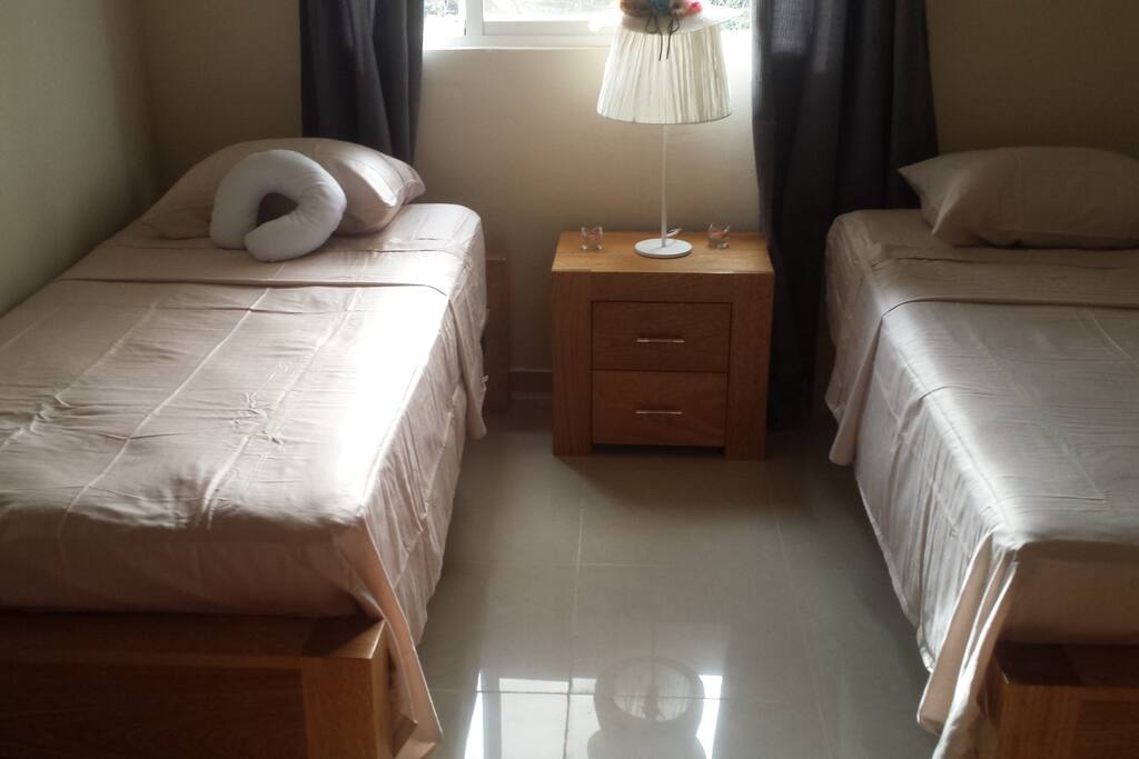 Sleeping with two twin size bed, spacious closet and common bathroom