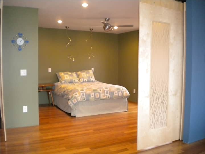 Primary Bedroom on main level. Walls slide and have resin/linen panels. Can be a bit light in the morning.