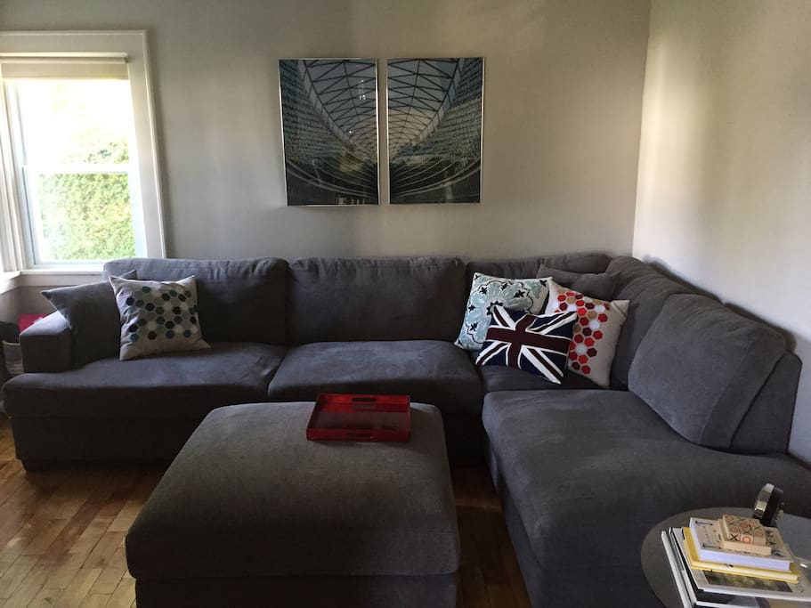 The living room has a 42" TV and a large, comfortable sectional couch to relax on.