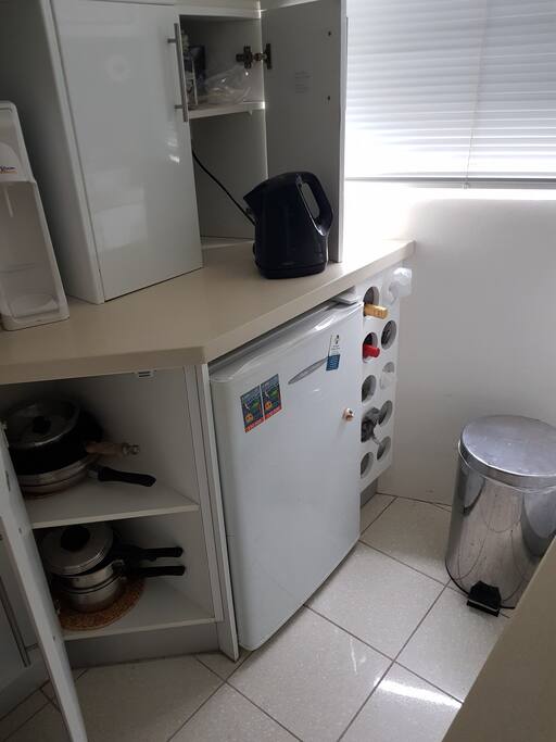 Kitchen showing fridge & Saucepans