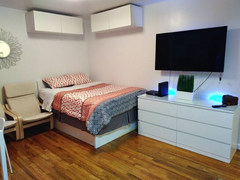 Studio setting with overhead cabinets for storage.