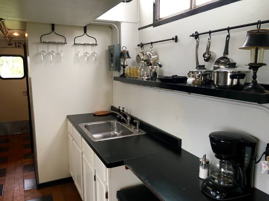 Fully stocked kitchen including refrigerator, microwave, electric burners, coffee pot, and all the accessories you need to make both a tasty meal...