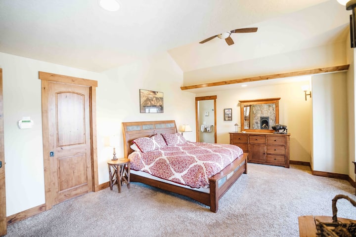 Main Level Master Bedroom with king bed, walk in closet, and full en suite bathroom