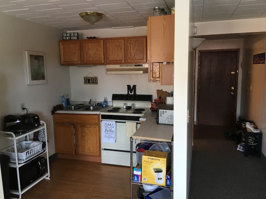 Kitchen with toaster oven, toaster, pizza maker, double sink, microwave, refrigerator, and oven.