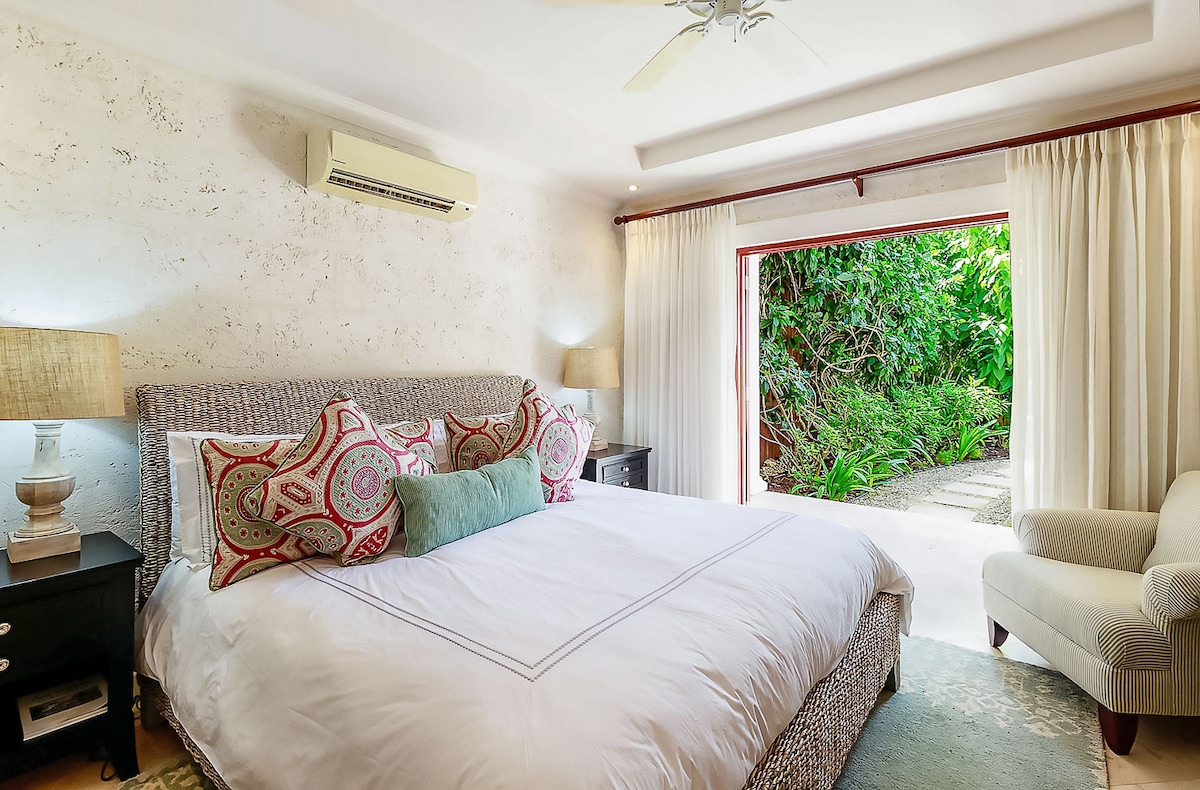 A beautiful bedroom with US king size bed, air conditioning, ceiling fan, security safe, walk in wardrobe, shred terrace and an en suite.