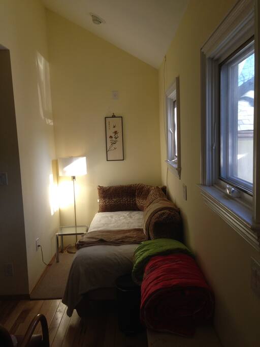Cozy Bed (twin-extra length) by night/couch- like by day with sunny terrace and yard view