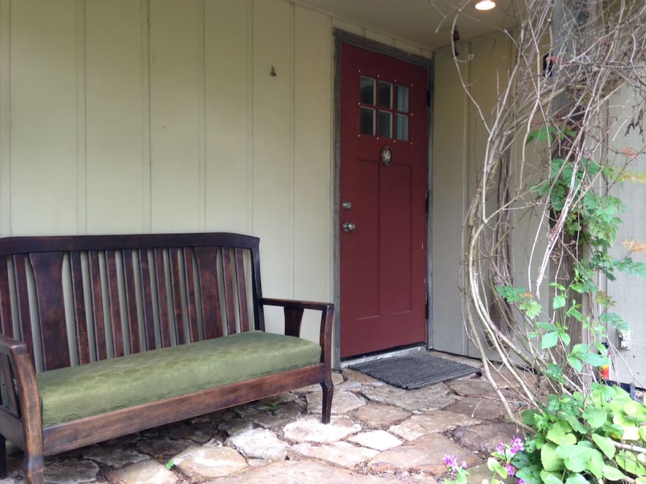 Rustic rock porch, couch and arts and crafts entry door