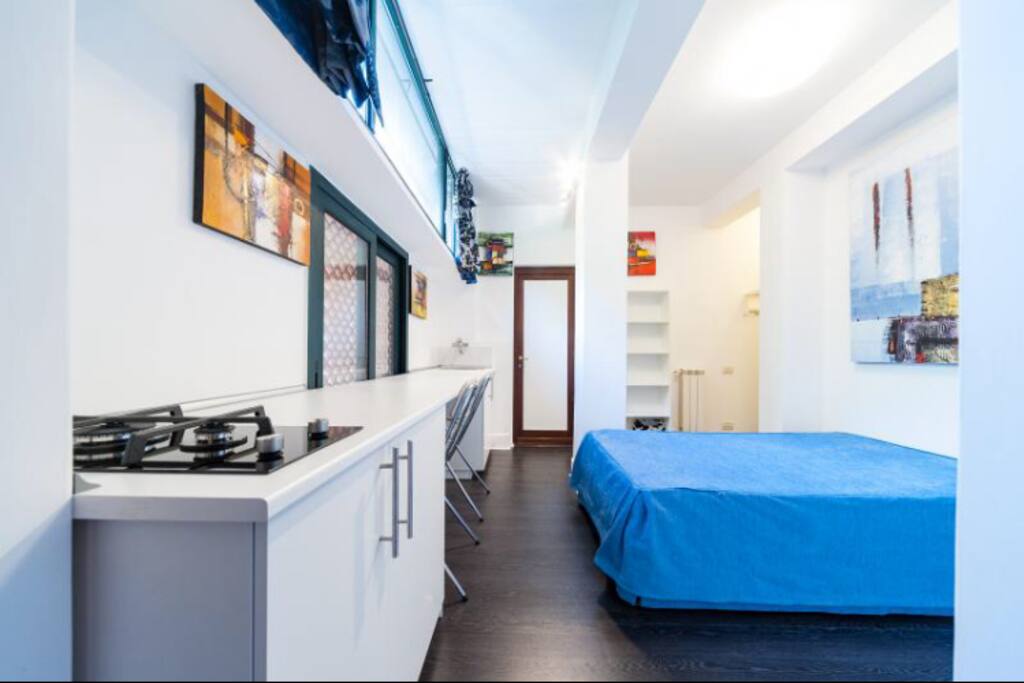 Stanza con letto e banco cucina
