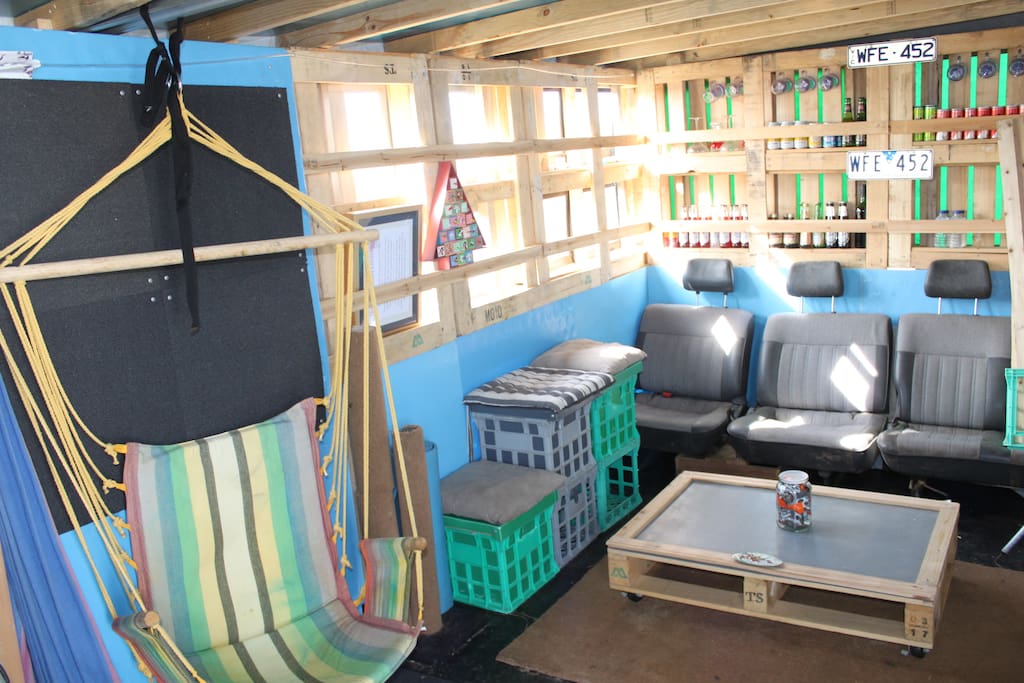 The living room in the open plan Rubbish Lounge. Features hammocks and a fully-stocked Dumpster Bar. Everything you see here apart from the van seats is someone else's rubbish.