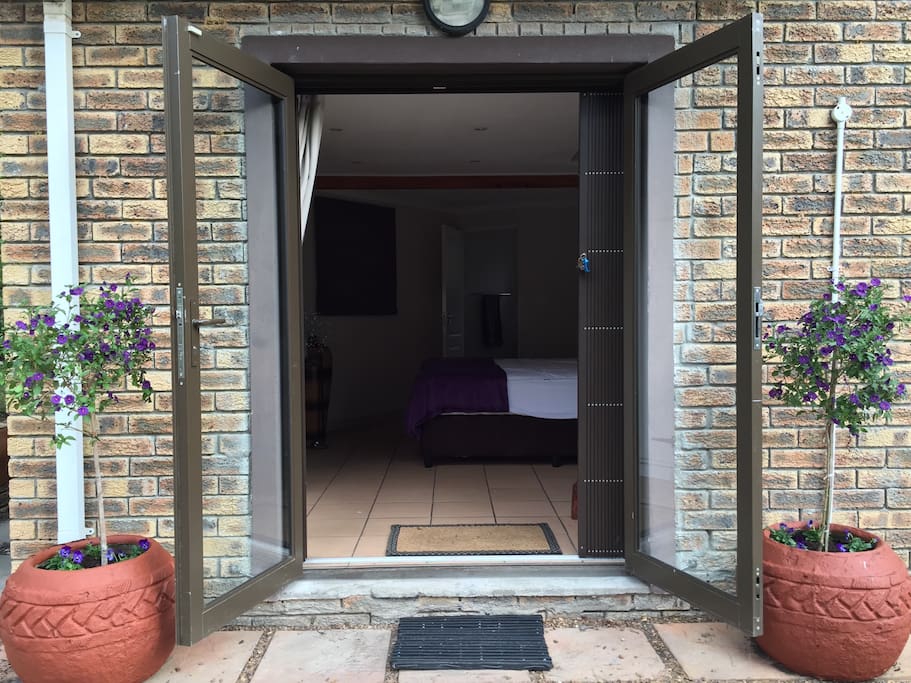 The bedroom opens out onto the garden where you can hear the Baviaanskloof River coming down off the mountain.