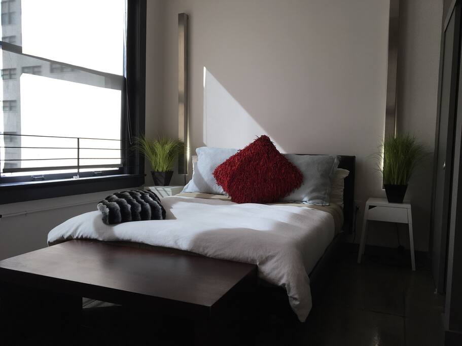Comfortable bed with soft decorative linens