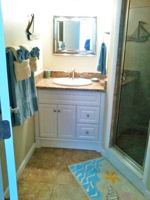 Fully renovated bath with granite counters and walk in shower