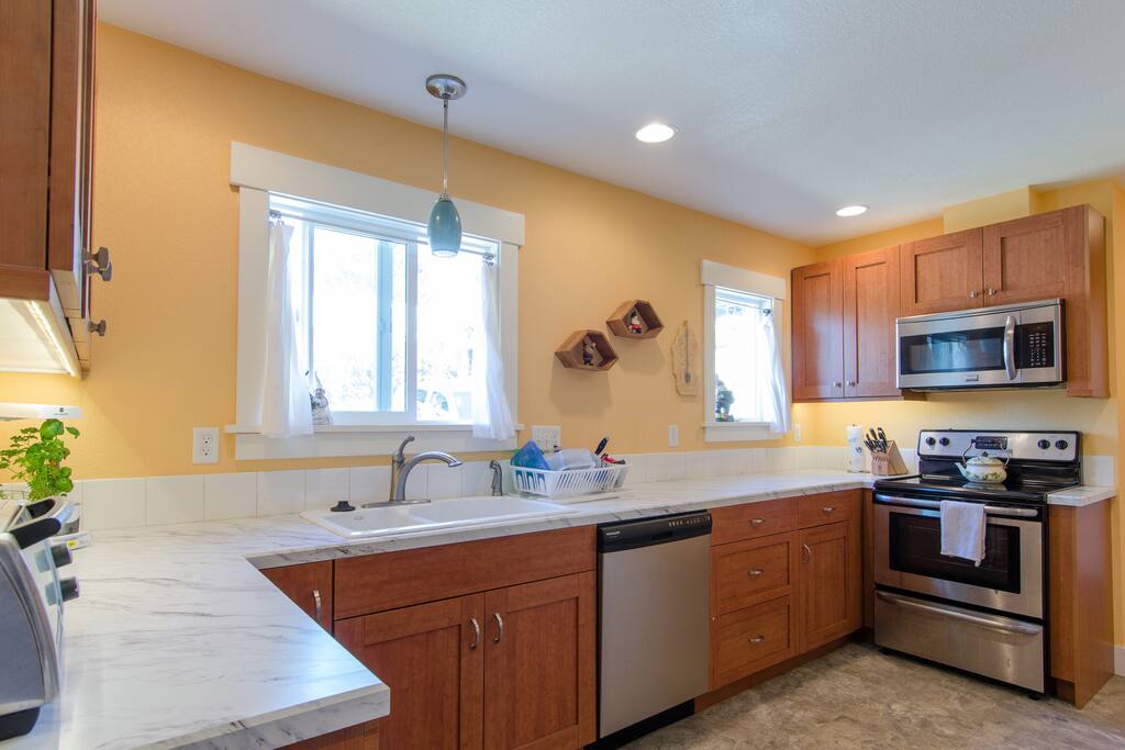 The well-equipped kitchen has everything needed for cooking and dining.