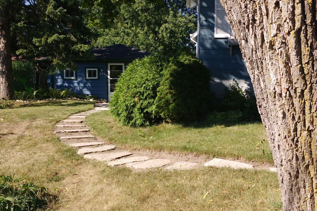 Enter a world of privacy-in-community up the winding stone path by the old maple tree.