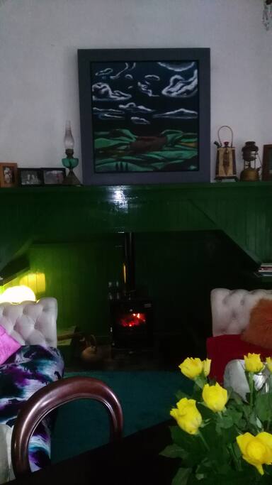 This is the Aula or main room for relaxing and dining. It features some lovely pieces of art by Tipperary based artists, has a dining table and two comfy chesterfield couches.