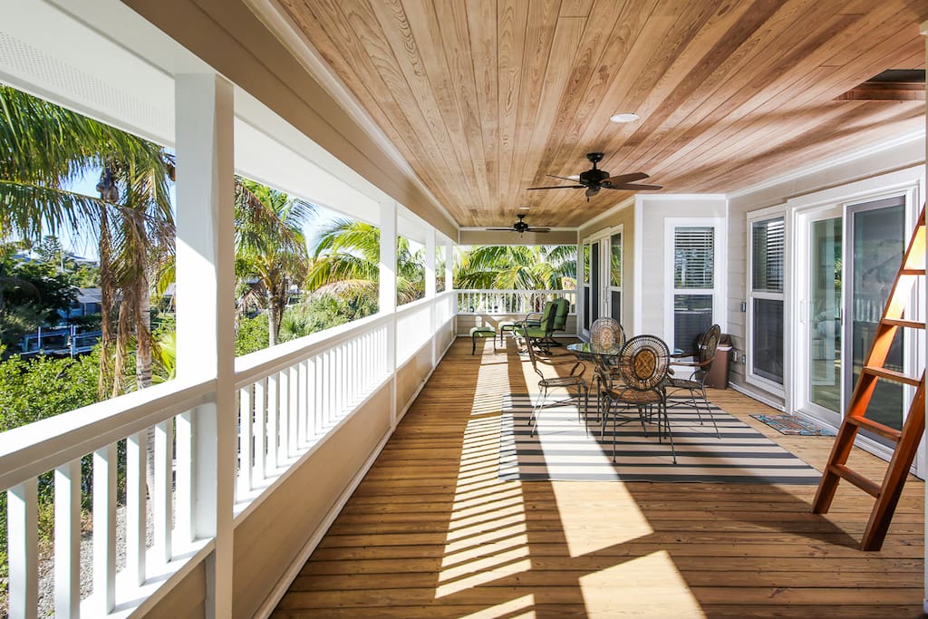 Relax on the expansive porch amid the swaying palms