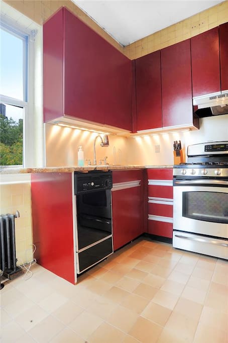 Kitchen with double oven, dishwasher and fridge.