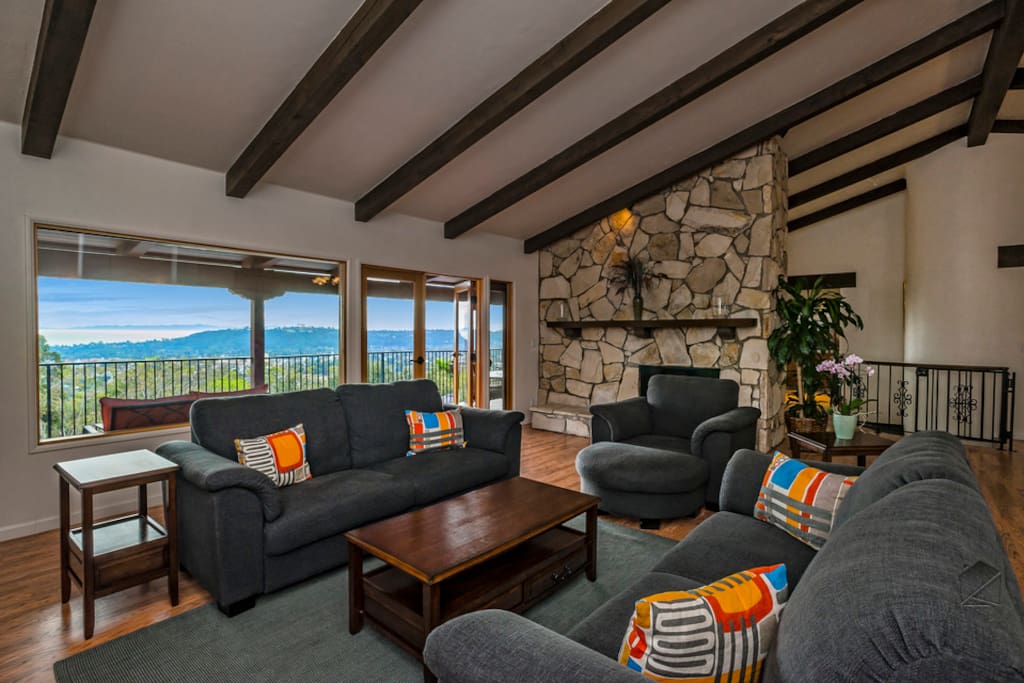 High ceilings in the living room creates a spacious atmosphere and the stone fireplace adds ambience.