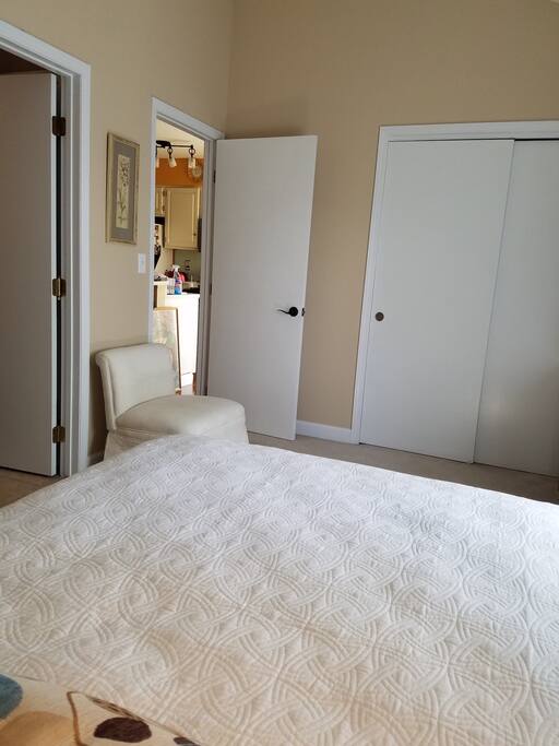 Bedroom has adjoining private bath and is adjacent to kitchen.
