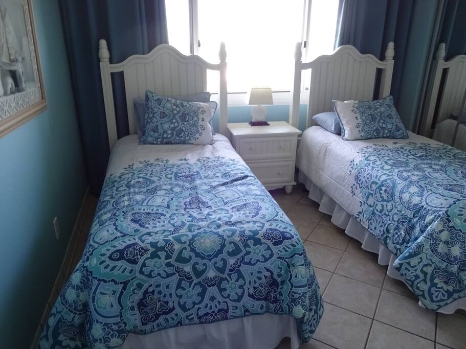 Guest bedroom with extra long beds overlooking Lake Powell. Full bath in hallway