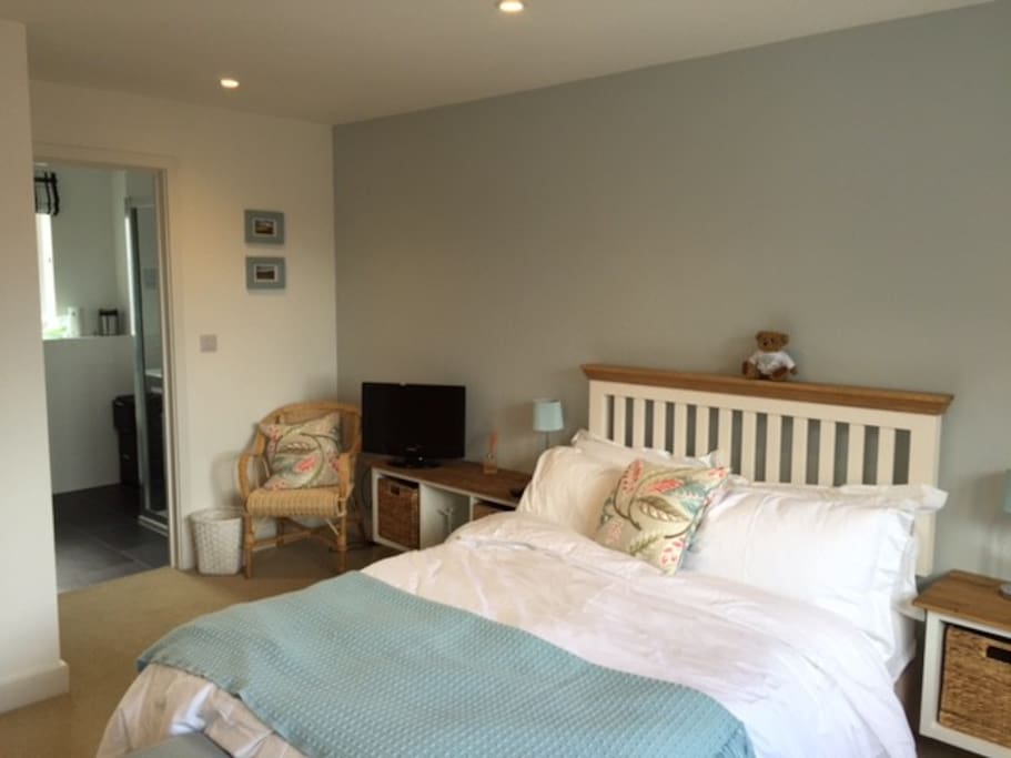 The bedroom with double bed, triple wardrobe and ensuite