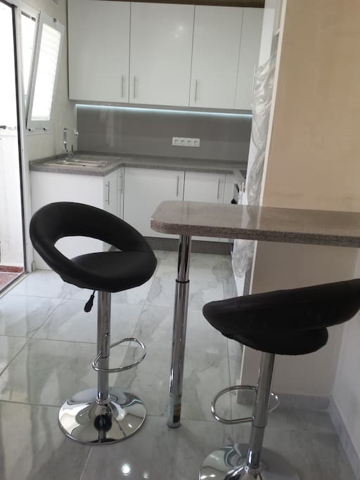 Fully fitted modern kitchen with breakfast bar area.