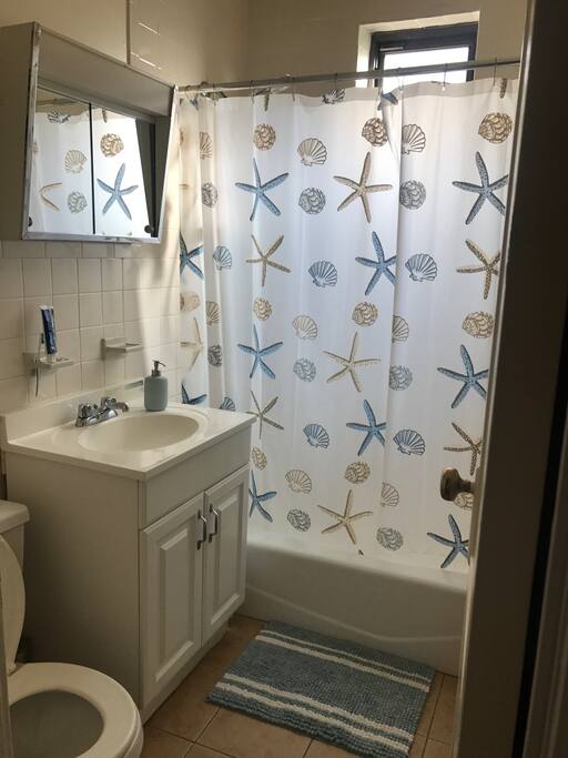 Bathroom with bathtub and shower. Scale available also. :)