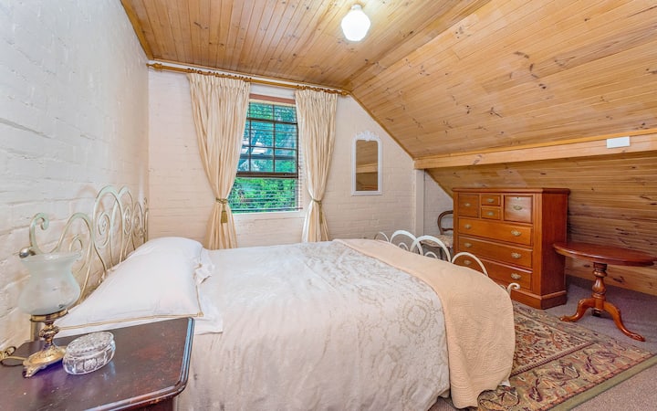 Upstairs attic bedroom with queen bed, block out blinds and silk curtains.