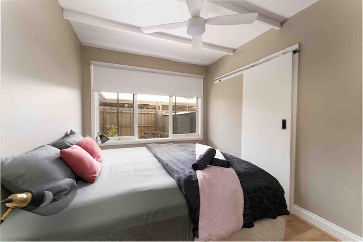 Segunda habitación/habitación principal con cama tamaño king y tocador/inodoro.