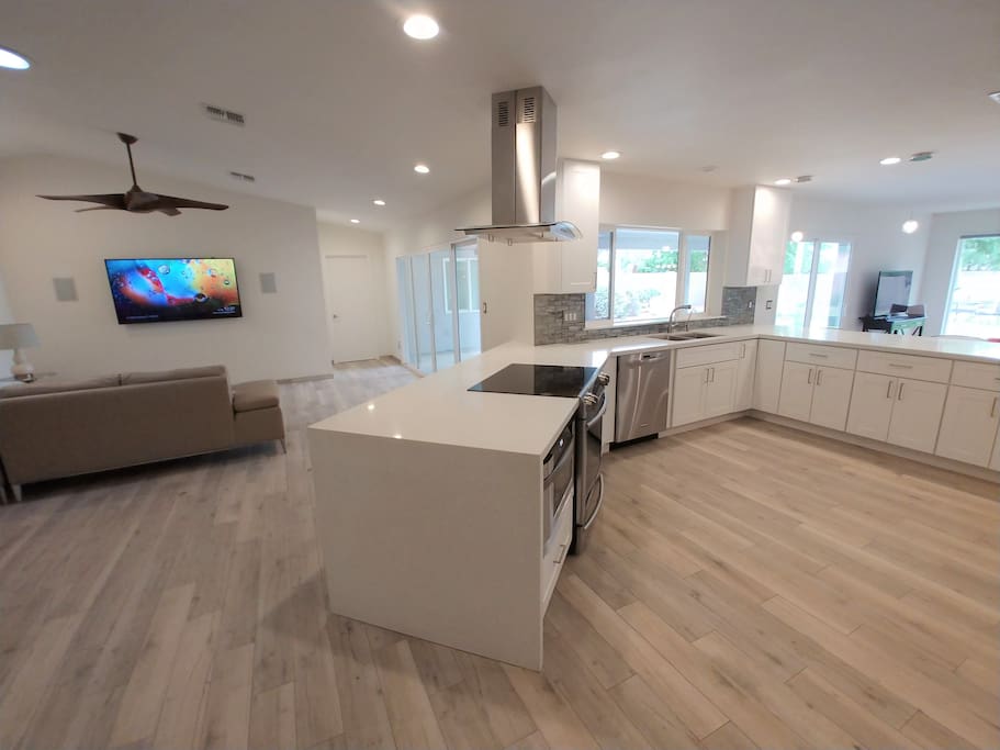 Open floor plan with spacious kitchen and natural light throughout
