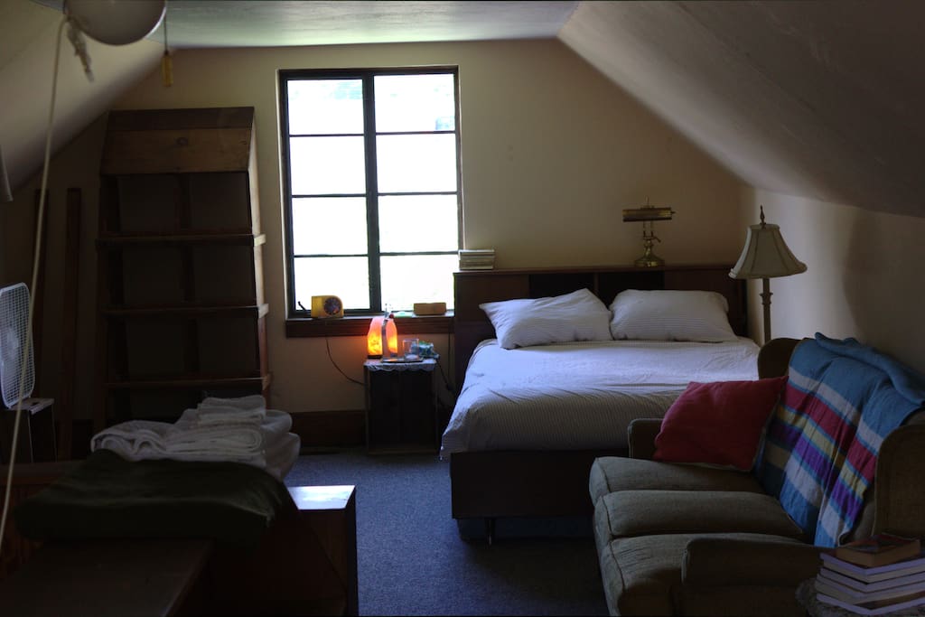 Vintage chicken-coop clothes shelf, Himalayan salt-lamp glow, and super-comfy full-size bed tucked into this attic hideaway -- maybe you want to stay forever?