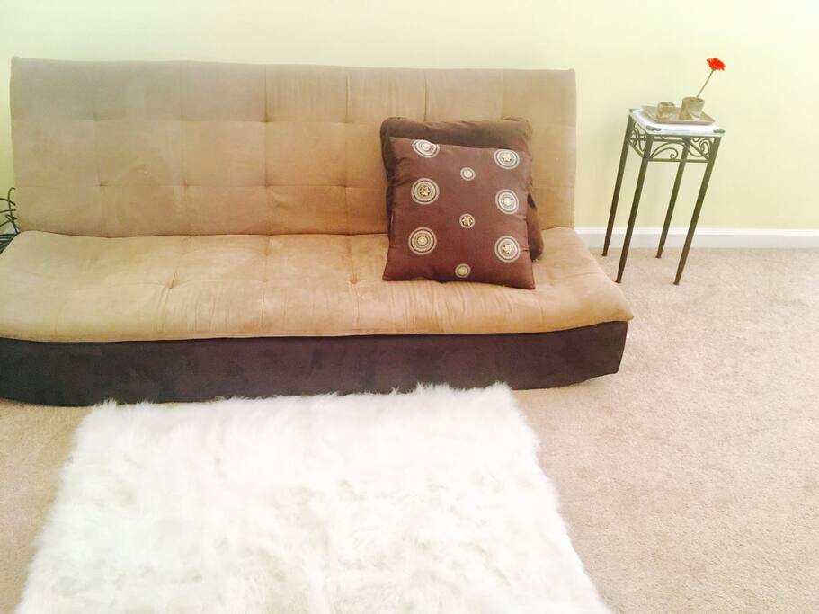 A new futon in loft space that can be used for additional guests to sleep.