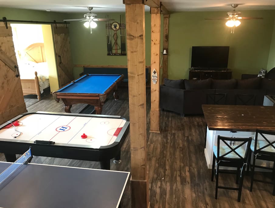 Living area includes tv, sectional couch, full size pool table, ping pong, air hockey, fooseball, darts and board games, full kitchen