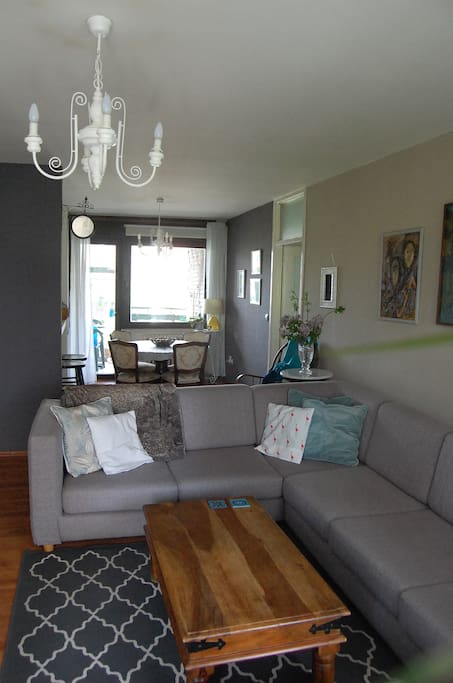 Open plan living room + dining room, with two balconies.