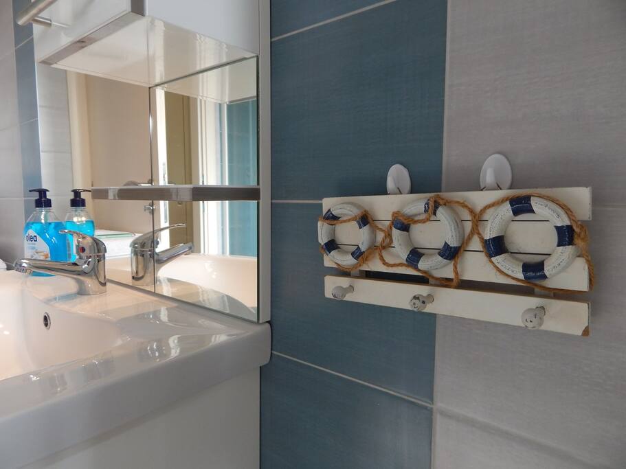 Bathroom with washing machine and towels provided